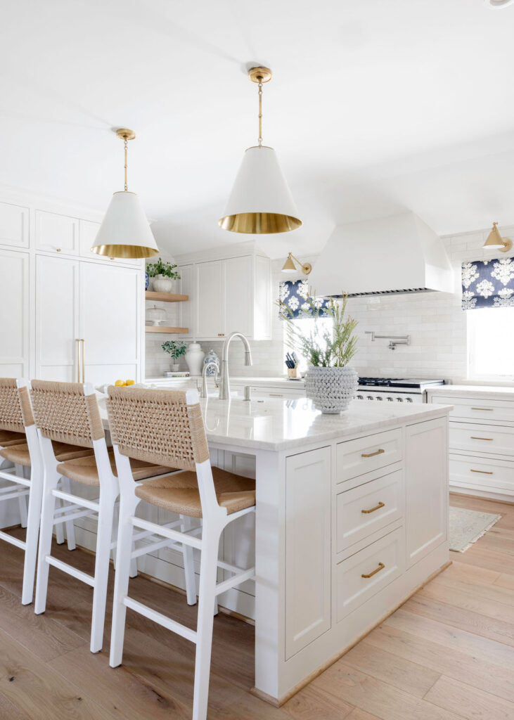 The kitchen, too, underwent a huge metamorphosis. They stripped away the dated cabinetry and replaced it with custom-built, soft neutral cabinets that offered both elegance and practicality. A spacious island became the heart of the kitchen, with a stunning slab of Taj Mahal quartzite that is truly a stunner. The subtle blend of countertops, textured backsplash and brass fixtures lent an air of sophistication without overwhelming the space.