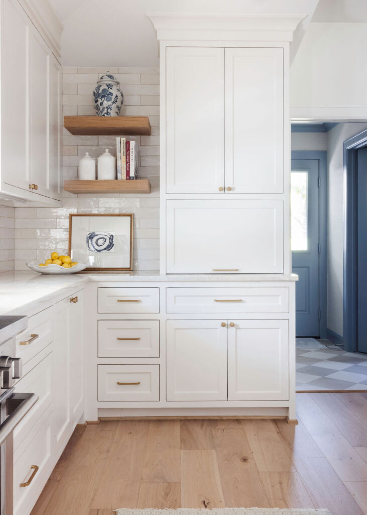 The kitchen, too, underwent a huge metamorphosis. They stripped away the dated cabinetry and replaced it with custom-built, soft neutral cabinets that offered both elegance and practicality. A spacious island became the heart of the kitchen, with a stunning slab of Taj Mahal quartzite that is truly a stunner. The subtle blend of countertops, textured backsplash and brass fixtures lent an air of sophistication without overwhelming the space.