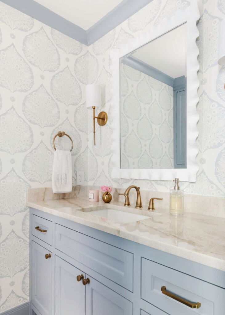 Let's not forget the powder bathroom, where we seamlessly merged classic elements with more whimsical patterned touches. Our team sourced an elegant wallpaper pattern with the most beautiful shades of blue and white. Right off the powder room is the mudroom, where we selected a chic "grasscloth" wallpaper - which is actually a vinyl! Kid-proof and still beautiful. Our clients say that everyone loves the checkered tile floors - in soft taupe and cream, the pattern is fun and visually so much more interesting than a single tone.