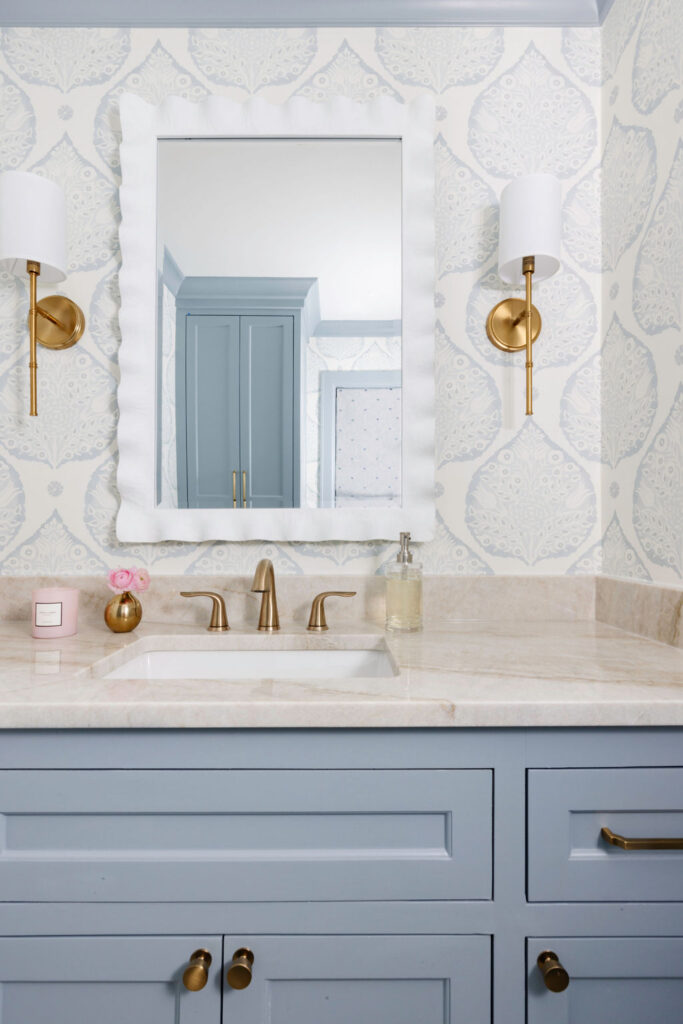 Let's not forget the powder bathroom, where we seamlessly merged classic elements with more whimsical patterned touches. Our team sourced an elegant wallpaper pattern with the most beautiful shades of blue and white. Right off the powder room is the mudroom, where we selected a chic "grasscloth" wallpaper - which is actually a vinyl! Kid-proof and still beautiful. Our clients say that everyone loves the checkered tile floors - in soft taupe and cream, the pattern is fun and visually so much more interesting than a single tone.